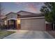 Well-maintained single-story home with a two-car garage, classic architecture, and a tidy front yard at 38208 N La Grange Ln, San Tan Valley, AZ 85140