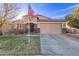 Delightful single-story home with a two-car garage, brick detailing, and lush green lawn at 38208 N La Grange Ln, San Tan Valley, AZ 85140