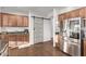 Kitchen with granite countertops, stainless steel refrigerator, and sliding barn door to pantry at 38208 N La Grange Ln, San Tan Valley, AZ 85140