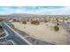 Aerial view of a community park, featuring open grass, trees, walking paths, and an American flag at 38208 N La Grange Ln, San Tan Valley, AZ 85140