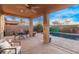 The back patio offers desert landscaping with outdoor seating and a view of the pool at 38208 N La Grange Ln, San Tan Valley, AZ 85140