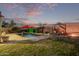 Backyard pool featuring a red umbrella, shaded seating, and a fire pit, perfect for outdoor entertaining at 38208 N La Grange Ln, San Tan Valley, AZ 85140