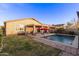 Backyard with pool, desert landscaping and a covered patio providing a relaxing outdoor living space at 38208 N La Grange Ln, San Tan Valley, AZ 85140