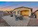 Large brick-paved backyard includes an outdoor dining set, a shed, and a basketball hoop at 4143 E Appaloosa Rd, Gilbert, AZ 85296