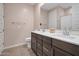 Bathroom features a double sink vanity with modern fixtures, a large mirror, and neutral color palette at 4143 E Appaloosa Rd, Gilbert, AZ 85296