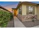 Inviting home entrance with a stone facade, a decorative door, and charming dark-green shutters at 4143 E Appaloosa Rd, Gilbert, AZ 85296