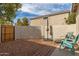 A cozy back yard featuring a stone groundcover, seating, and a privacy wall at 4226 E Spawn Ln, Gilbert, AZ 85296