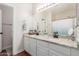 Modern bathroom with dual sinks, granite countertops, and a large mirror at 4226 E Spawn Ln, Gilbert, AZ 85296