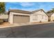 Charming single-story home featuring a two-car garage and neutral-toned stucco exterior at 4226 E Spawn Ln, Gilbert, AZ 85296