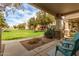 Covered front porch overlooks a lush green lawn, offering a serene outdoor living space at 4226 E Spawn Ln, Gilbert, AZ 85296