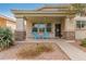 Cozy front porch featuring brick columns and inviting blue chairs for relaxing outdoors at 4226 E Spawn Ln, Gilbert, AZ 85296