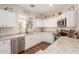 Bright kitchen with white cabinets, granite countertops, stainless steel appliances and modern fixtures at 4226 E Spawn Ln, Gilbert, AZ 85296