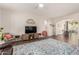 Spacious living room with wood floors, ceiling fan, and arched entryways to dining area at 4226 E Spawn Ln, Gilbert, AZ 85296