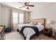 Comfortable main bedroom with a ceiling fan, natural light, neutral décor and ensuite bathroom at 4226 E Spawn Ln, Gilbert, AZ 85296