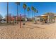 Neighborhood park with swings and playground covered in sand at 4226 E Spawn Ln, Gilbert, AZ 85296