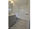 Bathroom featuring gray vanity and a tub shower combo with tiled floors at 4601 E Pollack Ln, Phoenix, AZ 85042