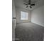 Cozy carpeted bedroom featuring a ceiling fan and natural light at 4601 E Pollack Ln, Phoenix, AZ 85042