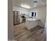 Well-lit kitchen with stainless steel appliances, white cabinets, and a breakfast bar at 4601 E Pollack Ln, Phoenix, AZ 85042