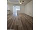 Bright living room with ceiling fan, wood-look floors, and open doorway to another room at 4601 E Pollack Ln, Phoenix, AZ 85042