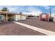 Expansive backyard featuring a detached shed, gravel landscaping, and a convenient walkway to the patio at 4626 W Mitchell Dr, Phoenix, AZ 85031