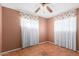 Bedroom with tile floor, window, curtains, and ceiling fan at 4626 W Mitchell Dr, Phoenix, AZ 85031