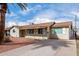 Single-story home with a long driveway, low-maintenance landscaping, and mature palm trees, capturing its curb appeal at 4626 W Mitchell Dr, Phoenix, AZ 85031