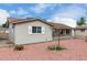 Side view of a single-story home with neutral siding and desert landscaping, showcasing its neat presentation at 4626 W Mitchell Dr, Phoenix, AZ 85031