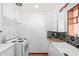 Bright kitchen features white cabinetry, a butcher block countertop, a farm sink, and stylish backsplash at 4626 W Mitchell Dr, Phoenix, AZ 85031