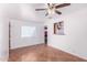 Bright and spacious living room with tile flooring, a ceiling fan, and a pass-through to the kitchen at 4626 W Mitchell Dr, Phoenix, AZ 85031