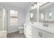 Bathroom featuring a double vanity, tiled floors, and glass-enclosed shower at 5145 W Tonto Rd, Glendale, AZ 85308