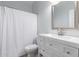 Clean bathroom features a modern vanity, framed mirror, and white shower curtain at 5145 W Tonto Rd, Glendale, AZ 85308