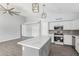 Spacious kitchen with white cabinets, stainless appliances, and an island with a marble countertop at 5145 W Tonto Rd, Glendale, AZ 85308