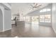 Living room with tile flooring, kitchen access, and view of the pool at 5145 W Tonto Rd, Glendale, AZ 85308