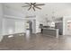 Open-concept living room with tile floors, kitchen access, and natural light at 5145 W Tonto Rd, Glendale, AZ 85308