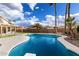 Backyard swimming pool boasts a diving board, clear blue water, and plenty of space to relax at 5145 W Tonto Rd, Glendale, AZ 85308