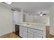 Functional kitchen features white cabinetry, laminate countertops, and a view into the open living area at 5230 E Brown Rd # 110, Mesa, AZ 85205