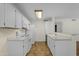 Bright kitchen featuring white appliances and cabinetry, offering a clean and functional cooking space at 5230 E Brown Rd # 110, Mesa, AZ 85205