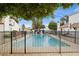 Community pool enclosed by a black fence offering a relaxing recreational space for residents at 5326 N 3Rd Ave, Phoenix, AZ 85013