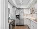 Well-lit kitchen featuring modern stainless steel appliances, white cabinets, and ample counter space for cooking at 5326 N 3Rd Ave, Phoenix, AZ 85013