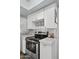 Modern kitchen featuring stainless steel appliances, white cabinets, and a tile backsplash, offering a sleek design at 5326 N 3Rd Ave, Phoenix, AZ 85013