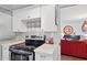 Stylish kitchen highlighting modern appliances, decorative backsplash, and an open view into the living area at 5326 N 3Rd Ave, Phoenix, AZ 85013