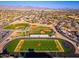 Aerial view of the sports area, including a football field, baseball field, and residential neighborhood at 5433 E Nisbet Rd, Scottsdale, AZ 85254