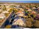 Wide aerial shot of home in a suburban neighborhood with mature trees lining streets and nearby mountains at 5433 E Nisbet Rd, Scottsdale, AZ 85254