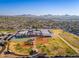 Areal view of a community with an expansive neighborhood, baseball fields, tennis courts, and local schools at 5433 E Nisbet Rd, Scottsdale, AZ 85254