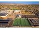 An aerial view showcases community tennis courts and sports fields surrounded by a residential neighborhood at 5433 E Nisbet Rd, Scottsdale, AZ 85254