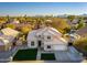 Stunning aerial view of a beautiful home showcasing its well-manicured lawn, pool, and desert landscaping at 5433 E Nisbet Rd, Scottsdale, AZ 85254