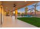 Covered back patio with ceiling fans offers views of the landscaped backyard at 5433 E Nisbet Rd, Scottsdale, AZ 85254