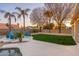 Beautiful backyard oasis with sleek patio seating, lush lawn, mature palm trees and privacy fencing at 5433 E Nisbet Rd, Scottsdale, AZ 85254