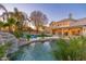 Lush backyard featuring pool, waterfall, mature trees and lounge area at 5433 E Nisbet Rd, Scottsdale, AZ 85254