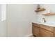 Stylish bar area with wood cabinets, white countertop, and open wooden shelving at 5433 E Nisbet Rd, Scottsdale, AZ 85254